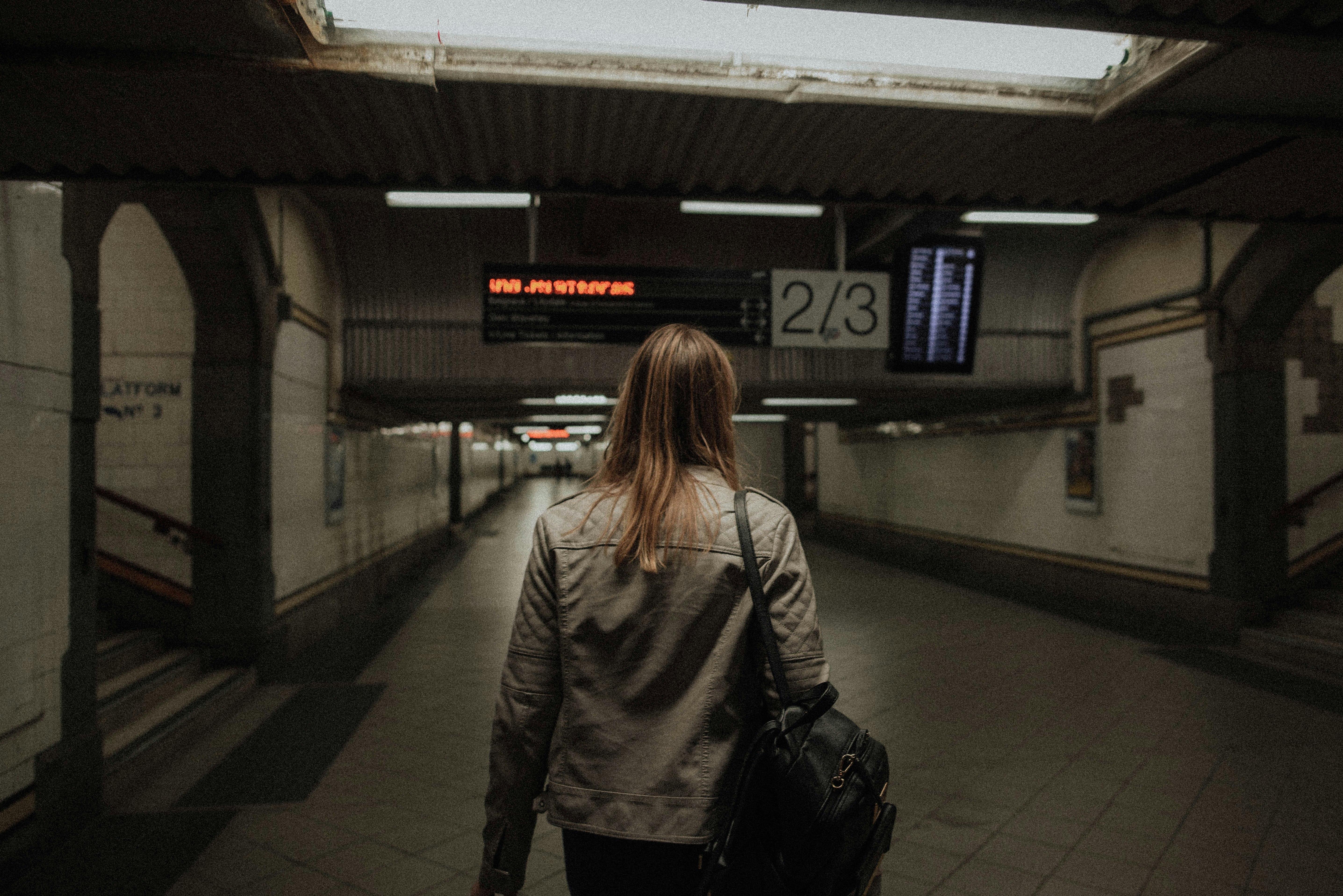 woman standing under tunnel